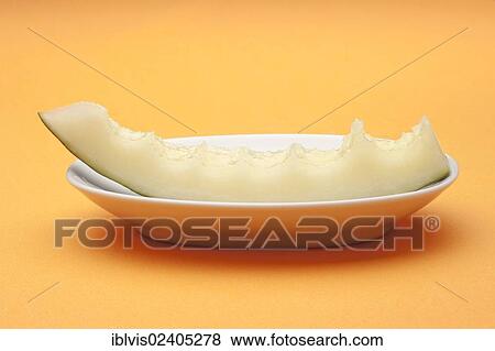 Half eaten slice of melon on a white plate View Large Photo Image Stock Photo - Half eaten slice of melon on a white plate. Fotosearch