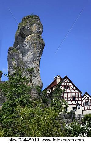 Stock Photo - "Half-timbered house next to towering karst rocks, Tuchersfeld, Pottenstein, Franconian Switzerland, Upper Franconia, Bavaria, Germany, Europe". Fotosearch