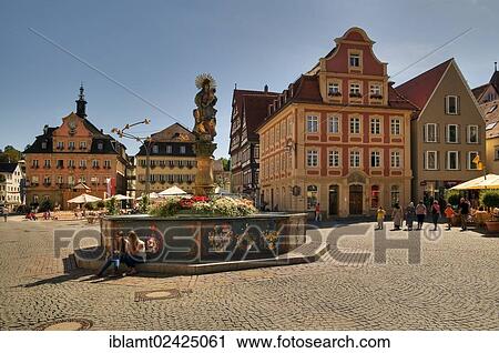 Stock Image - Half-timbered houses in the market square with Marienbrunnen fountain, Renaissance column, crowned by the double image of the Madonna in a steel ring, dated 1686, Schwaebisch Gmuend, Baden-Wuerttemberg, Germany, Europe. Fotosearch