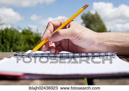 "Hand doodling with a pencil in a notebook, outside" View Large Photo Image Stock Image - "Hand doodling with a pencil in a notebook, outside". Fotosearch