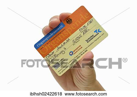 Stock Photo - Hand holding a filled-out organ donor card, fictional data. Fotosearch