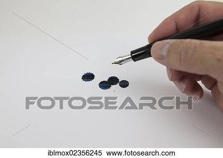 "Hand holding a fountain pen, blue ink drops on paper" View Large Photo Image Stock Photography - "Hand holding a fountain pen, blue ink drops on paper". Fotosearch
