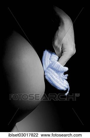 Hand making blue baby shoes walk on a pregnant belly View Large Photo Image Stock Image - Hand making blue baby shoes walk on a pregnant belly. Fotosearch