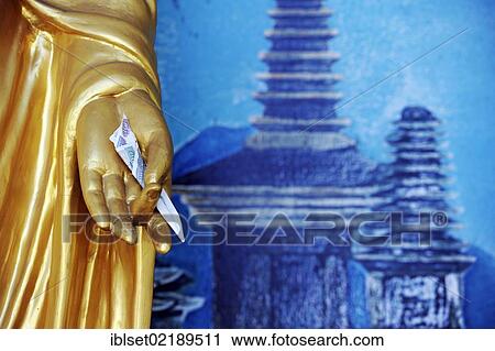 "Hand of a Buddha statue holding a banknote, donation, temple, Yangon, Myanmar, Burma, Southeast Asia, Asia" View Large Photo Image Stock Image - "Hand of a Buddha statue holding a banknote, donation, temple, Yangon, Myanmar, Burma, Southeast Asia, Asia". Fotosearch