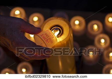 "Hand of a devotee lightening a candle for offering inside the Frauenkirche church, Dresden, Saxony, Germany, Europe" View Large Photo Image Stock Image - "Hand of a devotee lightening a candle for offering inside the Frauenkirche church, Dresden, Saxony, Germany, Europe". Fotosearch