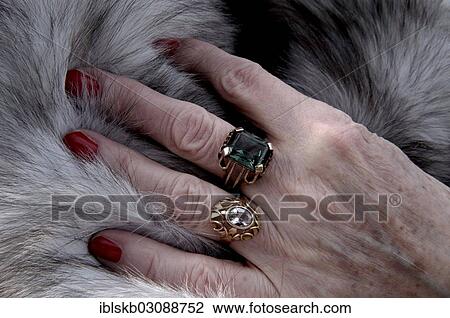 "Hand of an old woman with red painted nails and rings lying on a fur coat, detail" View Large Photo Image Stock Image - "Hand of an old woman with red painted nails and rings lying on a fur coat, detail". Fotosearch