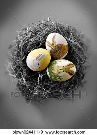 Stock Photo - Hand-painted chicken eggs with traditional Easter bunny design. Fotosearch