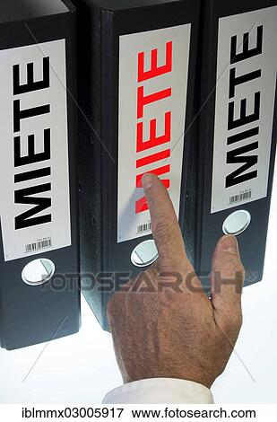 "Hand pointing to a file folder labeled """"Miete"""", German for """"Rent""""" View Large Photo Image Stock Photo - "Hand pointing to a file folder labeled """"Miete"""", German for """"Rent""""". Fotosearch