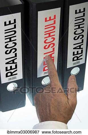"Hand pointing to a file folder labeled """"Realschule"""", German for """"middle school""""" View Large Photo Image Stock Photo - "Hand pointing to a file folder labeled """"Realschule"""", German for """"middle school""""". Fotosearch