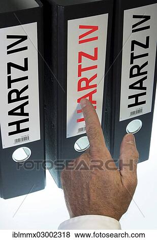 "Hand pointing to a ring binder labeled Hartz IV, German term for long-term unemployment benefits, symbolic image" View Large Photo Image Stock Photo - "Hand pointing to a ring binder labeled Hartz IV, German term for long-term unemployment benefits, symbolic image". Fotosearch