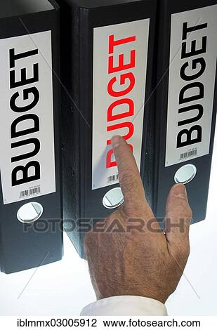 "Hand pointing to a ring binder labelled """"BUDGET""""" View Large Photo Image Stock Image - "Hand pointing to a ring binder labelled """"BUDGET""""". Fotosearch