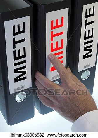 Stock Image - "Hand reaching for a file folder labeled """"Miete"""", German for """"Rent""""". Fotosearch