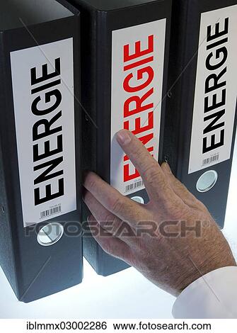 "Hand reaching for a ring binder labeled Energie, German for energy, symbolic image" View Large Photo Image Stock Photograph - "Hand reaching for a ring binder labeled Energie, German for energy, symbolic image". Fotosearch