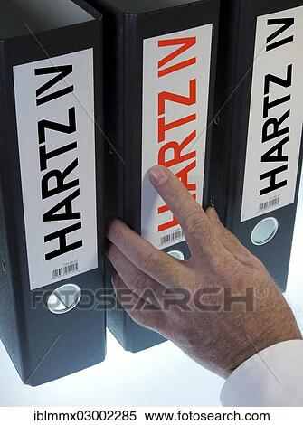 "Hand reaching for a ring binder labeled Hartz IV, German term for long-term unemployment benefits, symbolic image" View Large Photo Image Stock Photography - "Hand reaching for a ring binder labeled Hartz IV, German term for long-term unemployment benefits, symbolic image". Fotosearch