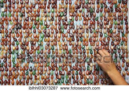 Stock Photo - "Hand reaching towards lucky charms, Beihai Park, Beijing, China, People's Republic of China, Asia". Fotosearch