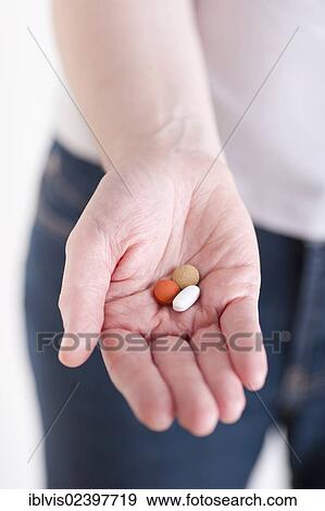 Hand showing three pills View Large Photo Image Stock Photo - Hand showing three pills. Fotosearch