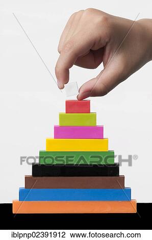 Stock Image - Hand stacking blocks. Fotosearch