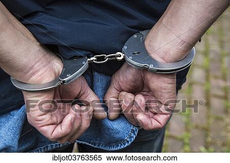 Stock Photography - "Handcuffed hands, North Rhine-Westphalia, Germany, Europe". Fotosearch