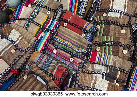Stock Photography - "Handmade bags with the traditional patterns of the Quechua Indians are displayed for sale, Cinchero, Urubamba Valley, Peru, South America". Fotosearch