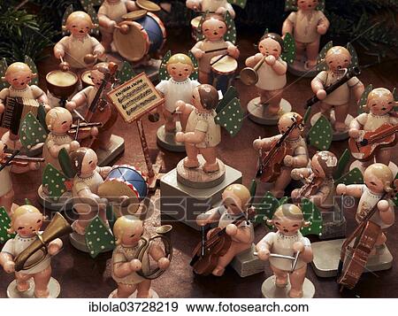 Stock Photo - "Handmade wooden angels playing musical instruments as a table decoration from the Erzgebirge or Ore Mountains, Germany, Europe". Fotosearch