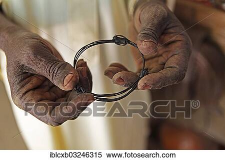 "Hands holding a bangle made from elephant tail bristles, Garoua, North Region, Cameroon, Africa" View Large Photo Image Stock Photography - "Hands holding a bangle made from elephant tail bristles, Garoua, North Region, Cameroon, Africa". Fotosearch