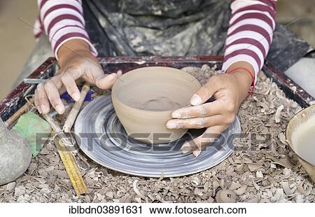 Hands molding a piece of pottery on a wheel head View Large Photo Image Stock Image - Hands molding a piece of pottery on a wheel head. Fotosearch
