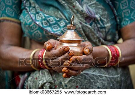 "Hands of an Indian woman holding a vessel with holy water, Rameswaram, Pamban Island, Tamil Nadu, India, Asia" View Large Photo Image Stock Photography - "Hands of an Indian woman holding a vessel with holy water, Rameswaram, Pamban Island, Tamil Nadu, India, Asia". Fotosearch