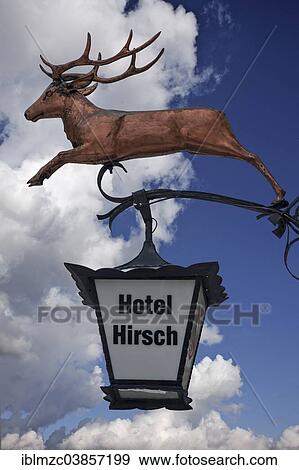 "Hanging sign of """"Hotel Hirsch"""" against a cloudy sky, Isny, Allgau, Bavaria, Germany, Europe" View Large Photo Image Stock Photo - "Hanging sign of """"Hotel Hirsch"""" against a cloudy sky, Isny, Allgau, Bavaria, Germany, Europe". Fotosearch