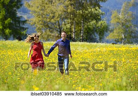 "Happy lovers running over a flower meadow in the spring, Tyrol, Austria, Europe" View Large Photo Image Stock Photography - "Happy lovers running over a flower meadow in the spring, Tyrol, Austria, Europe". Fotosearch