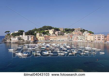 Stock Image - "Harbour in Baia del Silenzio bay, at the back Chiesa di San Nicolo church and the Grand Hotel dei Castelli, Sestri Levante, Province of Genoa, Riviera di Levante, Liguria, Italy, Europe". Fotosearch