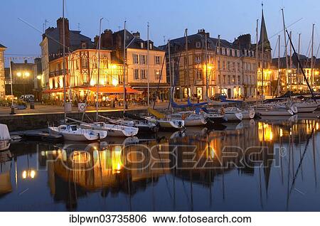 Stock Photograph - "Harbour scene with yachts and harbour restaurants at night, Honfleur, Normandy, France, Europe". Fotosearch