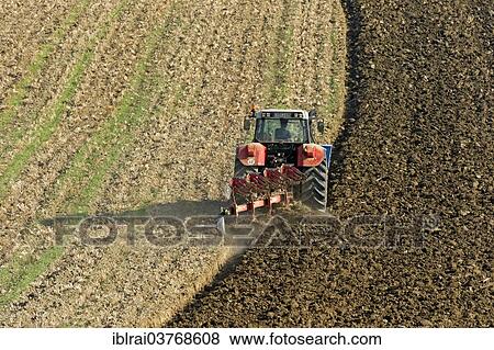 Stock Photo - "Harvested field is plowed with tractor and plow, Upper Bavaria, Bavaria, Germany, Europe". Fotosearch