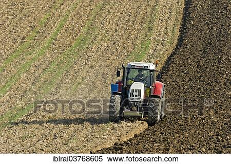 "Harvested field is plowed with tractor and plow, Upper Bavaria, Bavaria, Germany, Europe" View Large Photo Image Stock Photography - "Harvested field is plowed with tractor and plow, Upper Bavaria, Bavaria, Germany, Europe". Fotosearch