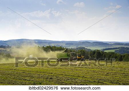 Stock Photograph - "Harvester in action on a field, Wolkenstein, Ore Mountains, Saxony, Germany, Europe". Fotosearch