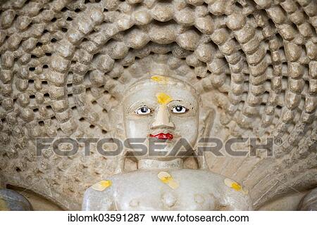 Stock Photo - "Head of Tirthankar Parshvanat in the medallion protected by the thousand-headed serpent God Dharanendra against a powerful storm, marble temple, Adinatha Temple, temple of the Jain religion, Ranakpur, Rajasthan, India, Asia". Fotosearch