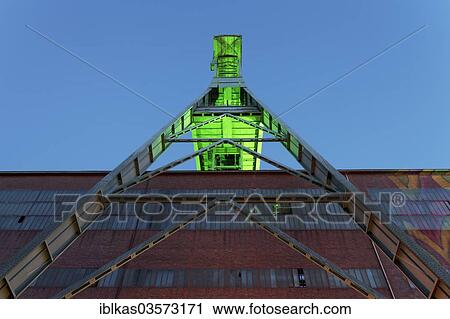 Stock Image - "Headframe over mine shaft No. 7, illuminated during ExtraSchicht, a night of industrial culture, disused coal mine of Zeche Ewald Colliery, Herten, Ruhr district, North Rhine-Westphalia, Germany, Europe". Fotosearch