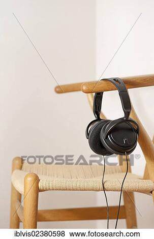 Headphone hanging on wooden chair View Large Photo Image Stock Photo - Headphone hanging on wooden chair. Fotosearch