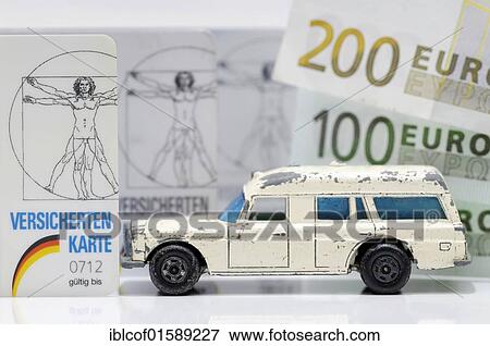 Stock Photo - "Health insurance cards and miniature ambulance, symbolic image for financial difficulties of health insurances". Fotosearch