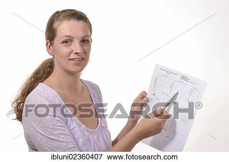 Stock Photo - Hearing aid acoustician with an audiogram for the assessment of hearing. Fotosearch