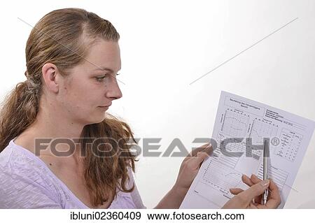 Stock Photo - Hearing aid acoustician with an audiogram for the assessment of hearing. Fotosearch