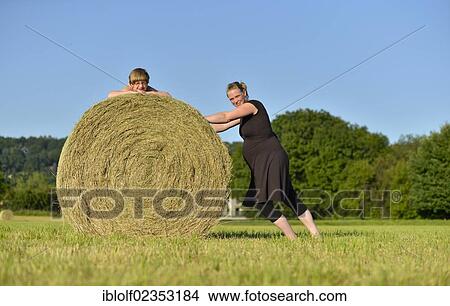 "Heavily pregnant women, nine months, and girl, six years, lying on a straw bale, Germany, Europe" View Large Photo Image Picture - "Heavily pregnant women, nine months, and girl, six years, lying on a straw bale, Germany, Europe". Fotosearch