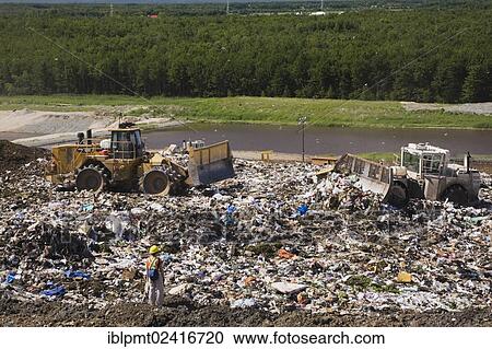 Heavy machinery spreading out and compacting discarded debris and trash at a waste management site, Quebec, Canada, North America View Large Photo Image Stock Image - Heavy machinery spreading out and compacting discarded debris and trash at a waste management site, Quebec, Canada, North America. Fotosearch