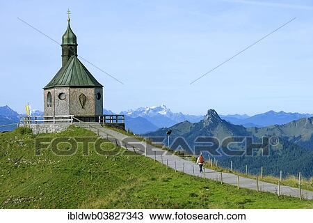 Stock Image - "Heilige Kreuzerhohung chapel, the mountains Leonhardstein, Wetterstein and Zugspitze at the back, Wallberg mountain, Tegernsee Mountains, Upper Bavaria, Bavaria, Germany, Europe". Fotosearch
