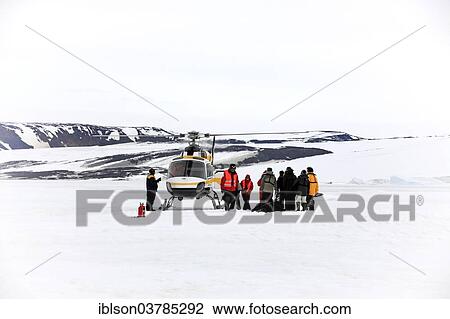 Stock Image - "Helicopter and tourists, Devil Island, Weddell Sea, Antarctica". Fotosearch