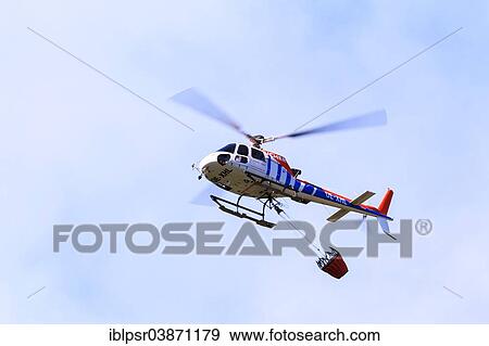"Helicopter with a water bucket during a forest fire, Tyrol, Austria, Europe" View Large Photo Image Stock Photo - "Helicopter with a water bucket during a forest fire, Tyrol, Austria, Europe". Fotosearch