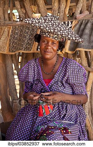 "Herero woman with typical headdress sewing souvenirs, Namibia, Africa" View Large Photo Image Stock Photo - "Herero woman with typical headdress sewing souvenirs, Namibia, Africa". Fotosearch