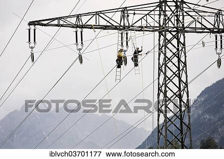 "High-voltage service technicians installing a new high voltage power line, Wiesing, Schwaz District, North Tirol, Tirol, Austria, Europe" View Large Photo Image Stock Photo - "High-voltage service technicians installing a new high voltage power line, Wiesing, Schwaz District, North Tirol, Tirol, Austria, Europe". Fotosearch