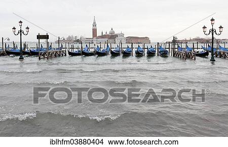 "High water or acqua alta in St Mark's Square, Santa Maria Maggiore at the back, Venice, Veneto, Italy, Europe" View Large Photo Image Picture - "High water or acqua alta in St Mark's Square, Santa Maria Maggiore at the back, Venice, Veneto, Italy, Europe". Fotosearch