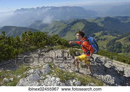 Stock Photo - "Hiker ascending Geigelstein Mountain, Chiemgau, Bavaria, Germany, Europe". Fotosearch