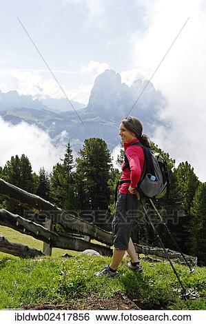 Hiker at the Raschotz or Rasciesa mountain pasture with Mt. Sasso Lungo, near St. Ulrich, Val Gardena valley, Southern Tyrol, Alto Adige, Italy, Europe View Large Photo Image Stock Photograph - Hiker at the Raschotz or Rasciesa mountain pasture with Mt. Sasso Lungo, near St. Ulrich, Val Gardena valley, Southern Tyrol, Alto Adige, Italy, Europe. Fotosearch